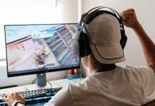 Teen boy playing video games at home on his computer