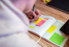 Teenager recording assignments in a planner